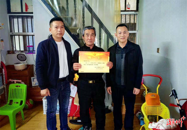 楊江松一行在汫洲鎮(zhèn)東灶村送立功喜報。